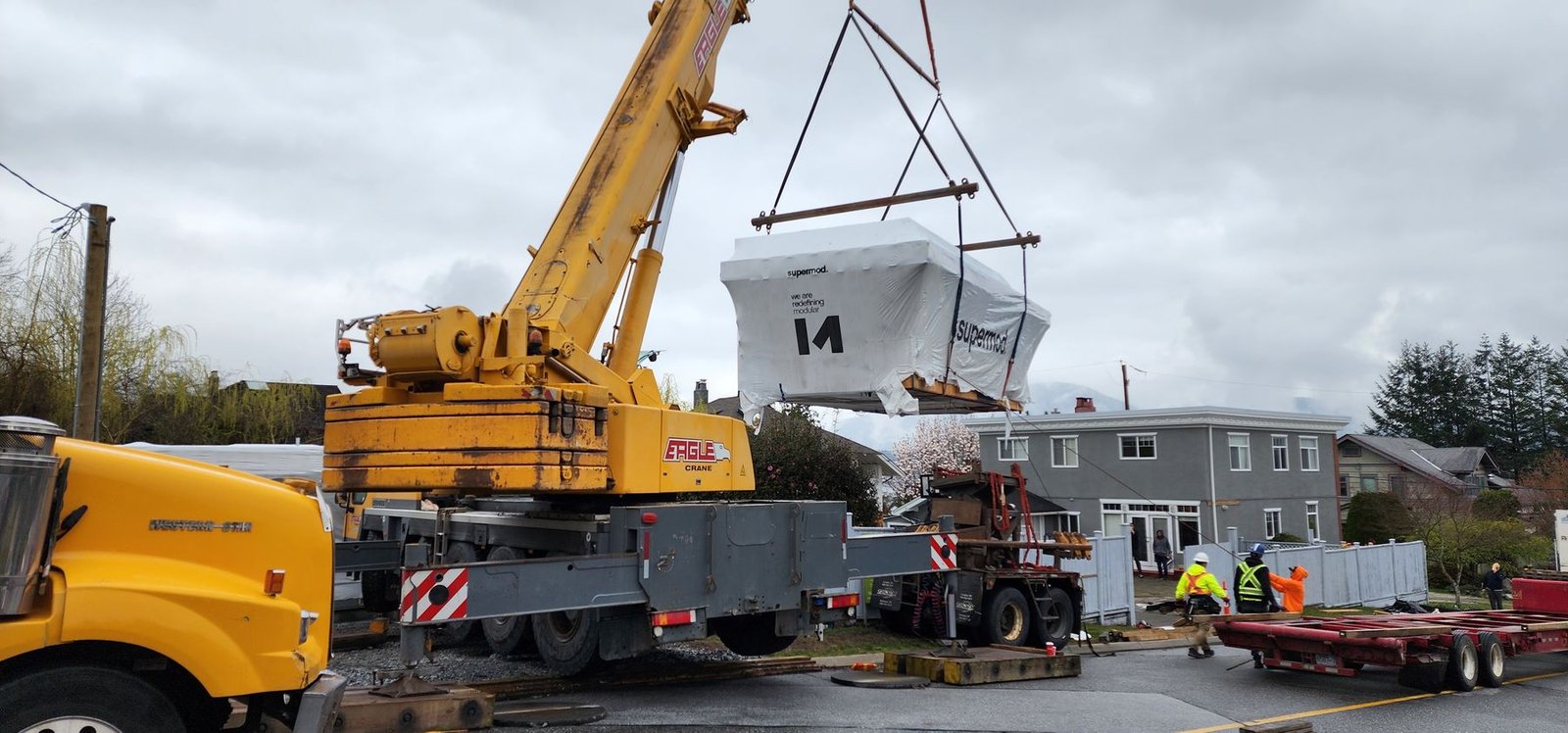 Crane lifting a finished module into place